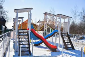 a playground with a slide in the snow at Trio Hotel Restaurant in Ivano-Frankivsk