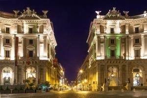 a view of two buildings at night at Bloom Apartment by La Griffe in Rome