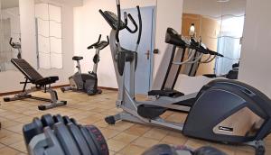 a gym with several exercise bikes in a room at Hotel Negritella in Folgarida