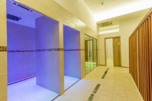 a hallway with purple walls in a building at The Pelican Beach Resort & SPA - Adults Only in Olbia