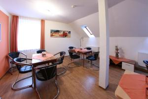 a room with two tables and chairs and a window at Pension Am Ostbahnhof in Gotha