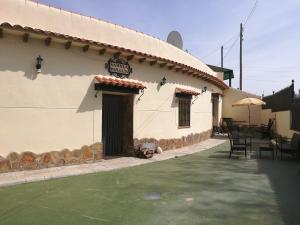 a building with a sign on the side of it at Cueva Peralta in Cortes de Baza