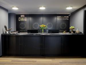 a kitchen with a white counter top and a black counter top at Hotel Cinnah in Ankara