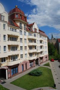 duży biały budynek z czerwonym dachem w obiekcie 3-Pokojowy Apartament Villa Park - Top Location w Olsztynie
