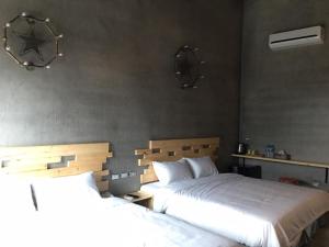 Postel nebo postele na pokoji v ubytování Kenting Xia Ye B&B