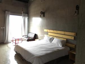 Postel nebo postele na pokoji v ubytování Kenting Xia Ye B&B