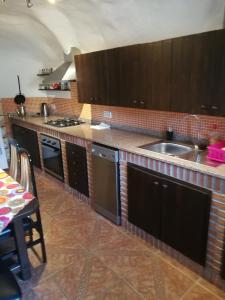 a kitchen with a sink and a counter top at Cueva Peralta in Cortes de Baza