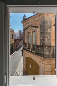 a view of a building from a window at Curniola in Ciutadella