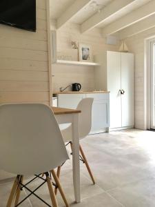 a kitchen with a table and chairs in a room at 8 Sosen Pobierowo in Pobierowo