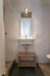 a bathroom with a sink and a mirror at Curniola in Ciutadella +36 photos