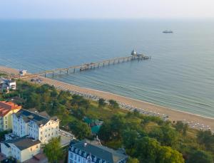 an aerial view of a pier next to the water at Haus Seeblick Hotel Garni & Ferienwohnungen in Zinnowitz