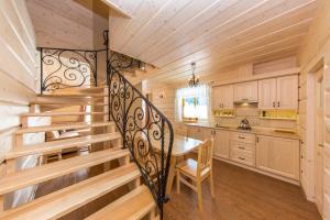 a kitchen with a spiral staircase in a house at Góralskie Zacisze Domki in Suche