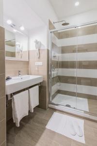 a bathroom with a sink and a shower at Bloom Apartment by La Griffe in Rome
