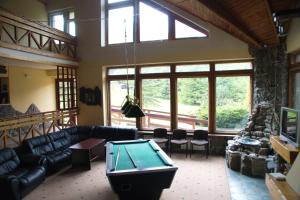 a living room with couches and a pool table at Perlyna Karpat in Slavske