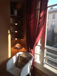 a chair in front of a window with a lamp at 36 M2 between Presqu'île and university in Lyon +3 photos