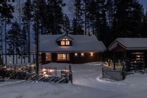 a house with lights in the snow at night at Aava Koli in Kolinkylä