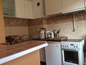 a kitchen with white cabinets and a stove top oven at 36 M2 between Presqu'île and university in Lyon