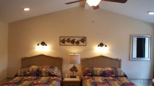 a bedroom with two beds and a ceiling fan at Atlantic Motel in Point Pleasant Beach