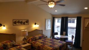 a hotel room with a bed and a table and a window at Atlantic Motel in Point Pleasant Beach
