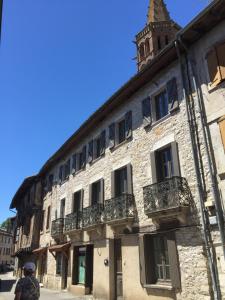 a man standing in front of a stone building at B&B Le Chat Qui Dort in Montricoux