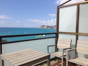 a balcony with chairs and a view of the ocean at Flats Friends Atlantida in Benidorm