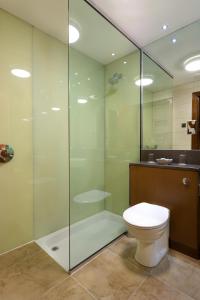 a bathroom with a toilet and a glass shower at The Bay Hotel in Kinghorn