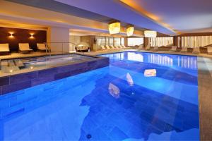 a large swimming pool in a hotel at Hotel Diamant in San Cassiano