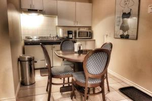 a kitchen with a table and chairs in a kitchen at Cozy Little Apartment #11 by Amazing Property Rentals in Gatineau