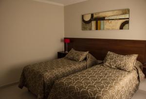 a small bedroom with a bed and a bed sqor at Apartaments Orquera in Sarmiento