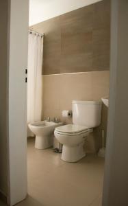 a bathroom with a toilet and a bidet at Apartaments Orquera in Sarmiento +9 photos