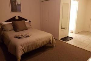 a bedroom with a large bed and a bathroom at Cozy Little Studio #16 by Amazing Property Rentals in Gatineau