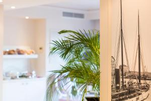 a picture of a model of a ship on a wall at Hotel Suisse in Nice