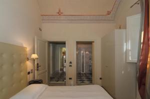 
Ein Bett oder Betten in einem Zimmer der Unterkunft Hotel Novecento
