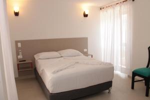 Postel nebo postele na pokoji v ubytování Akel House Hotel