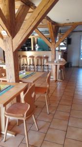 a dining room with wooden tables and chairs at Pension Forsthaus Täle - das Gästehaus vom Schwarzwaldgasthaus Salenhof in Titisee-Neustadt