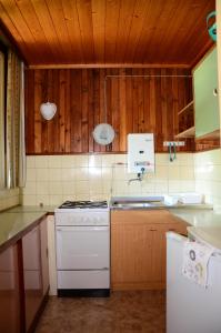a kitchen with a white stove and a sink at Bungalow Pipp in Passriach