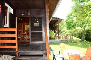 eine Veranda eines Hauses mit einem Tisch und Stühlen in der Unterkunft Bungalow Pipp in Passriach