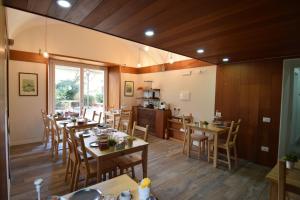 a dining room with wooden tables and chairs at Il Giardino in Tivoli