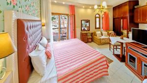 a bedroom with a bed and a living room at Olympic Apartments in Parga