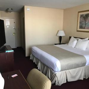 a hotel room with two beds and a television at Fireside Inn & Suites Portland in Portland