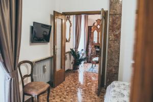 a room with a hallway with a chair and a mirror at Alla Terrazza Apartment in Verona