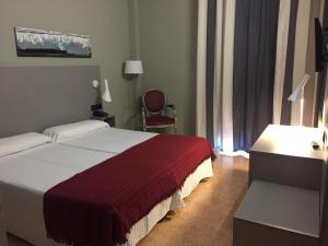 Postel nebo postele na pokoji v ubytování Hotel Valjunco
