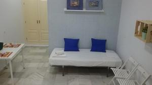 a bedroom with a bed, a desk, and a painting on the wall at Apartamentos Calle Eduardo Ocón in Málaga
