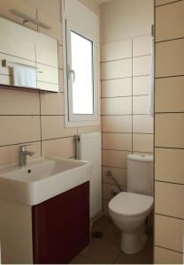 a bathroom with a sink and a toilet at Dip in the blue - 2 in Agios Georgios +46 photos