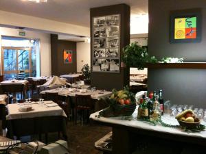 a dining room with tables and chairs with food on the table at Hotel Al Cason in Padova