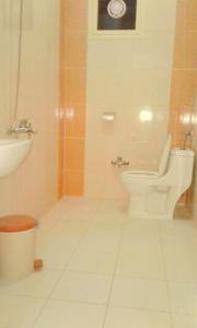 a bathroom with a toilet and a sink at Qsr Al Balsem Aparthotel in Unayzah +14 photos