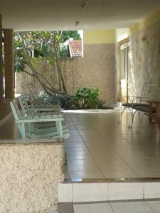 a lobby with two chairs and a table in a building at Hotel Columbia Palace in Pirassununga