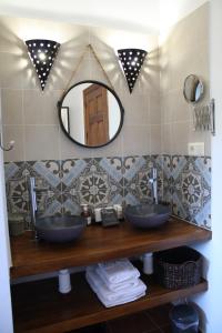 a bathroom with two sinks and a mirror at Boutique Bed & Breakfast Casa Utopia in Alcaucín