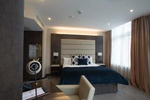um quarto de hotel com uma cama e um sofá em The Kings Head Hotel em Londres