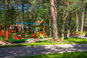 a playground with two play equipment in a park at Vējciems in Liepene